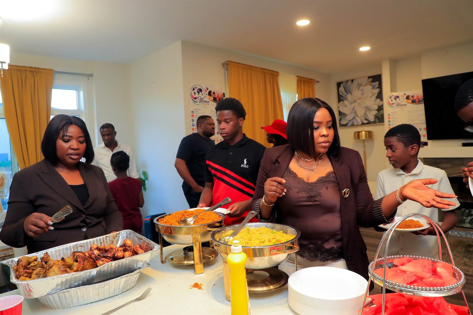 Community members serving and sharing food at a Women Beyond Borders Canada gathering