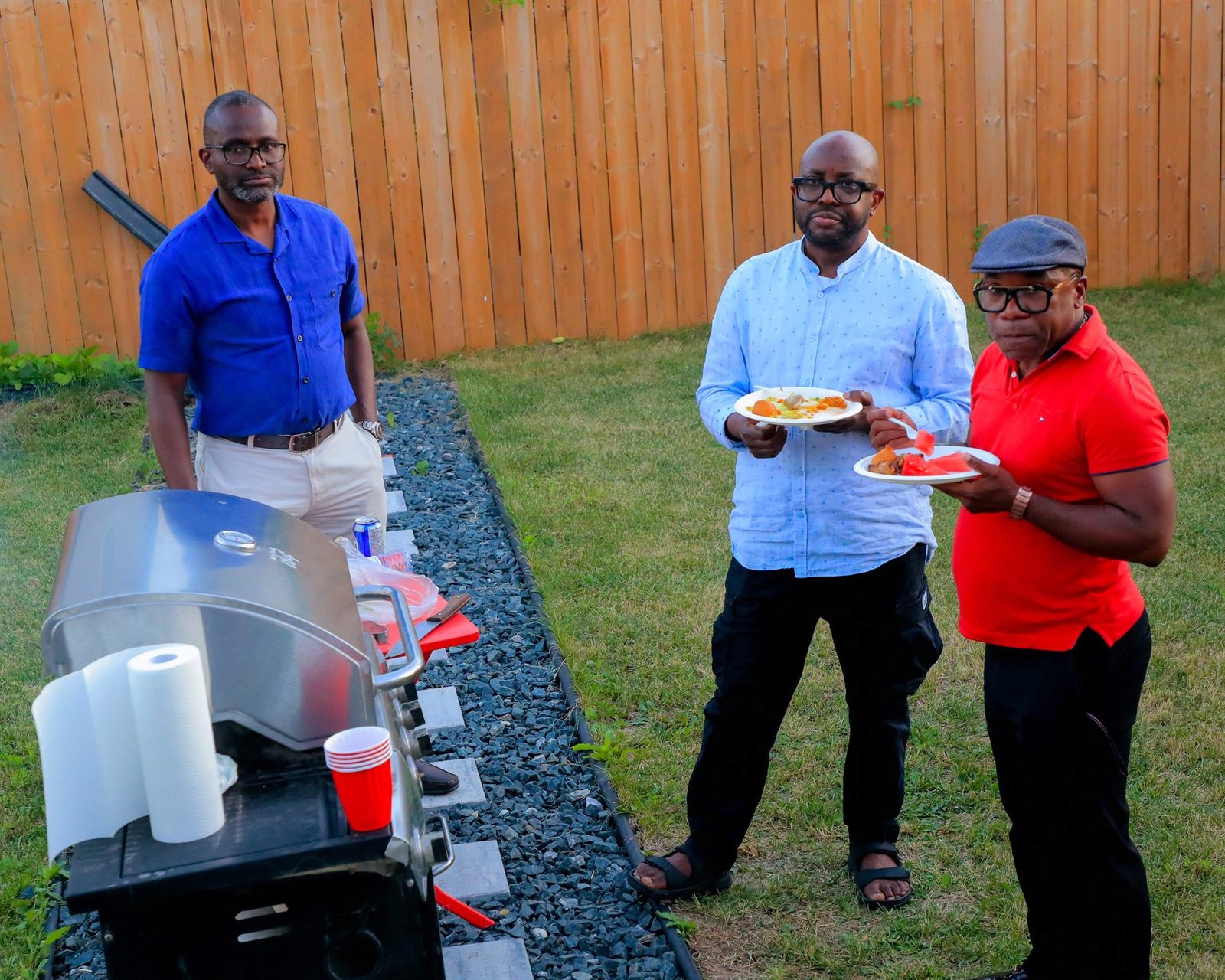 Community members gathered outdoors at a family barbecue